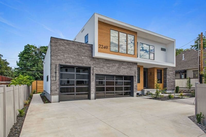 Modern two-story home with large windows and garage, located at 2249. Stylish exterior design.